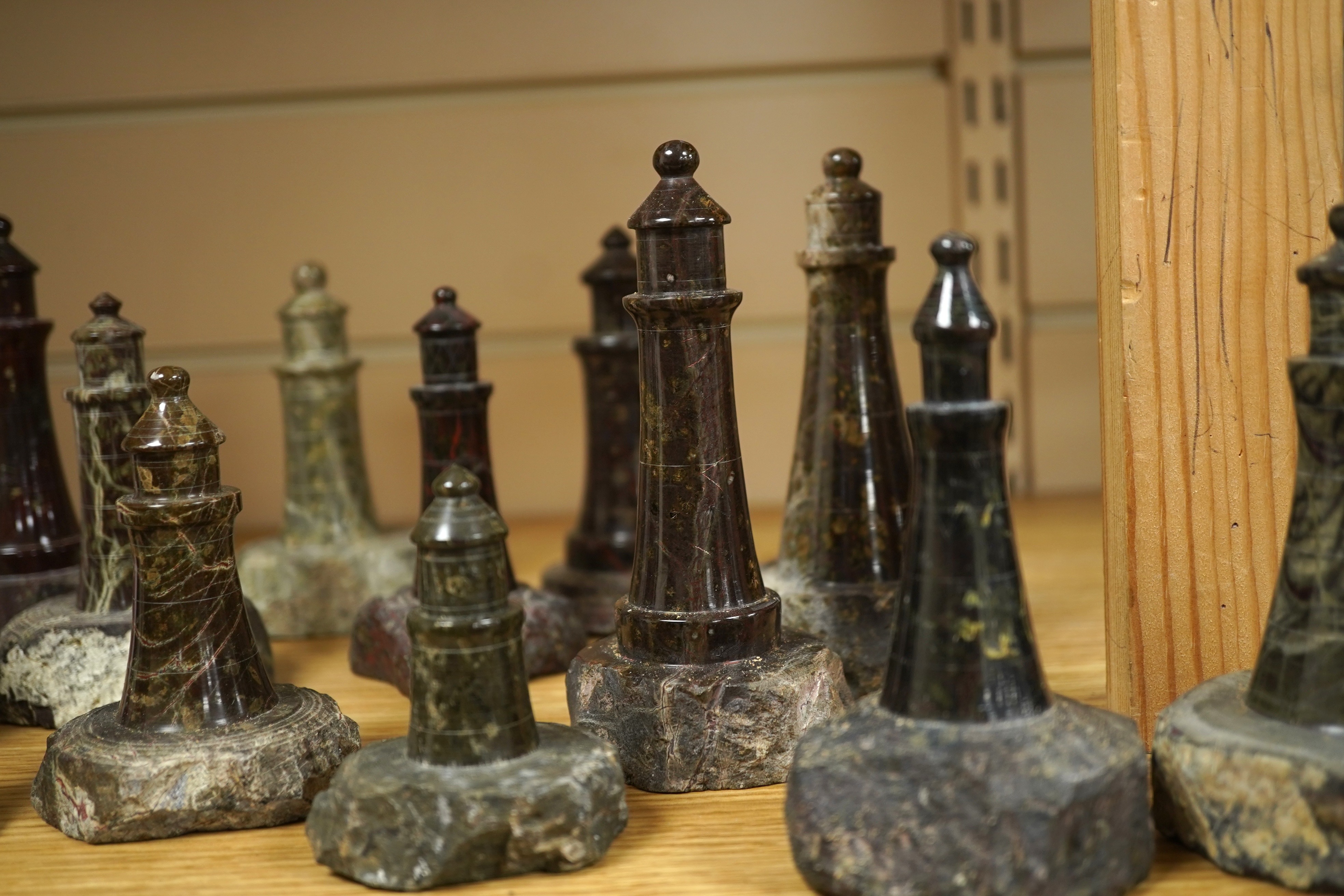 A collection of Cornish serpentine stone carved lighthouses, tallest 13cm high